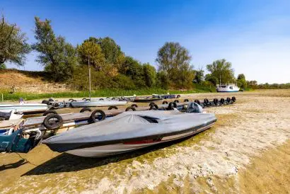 Small boats lying in the dried up river bed of the Po in Italy