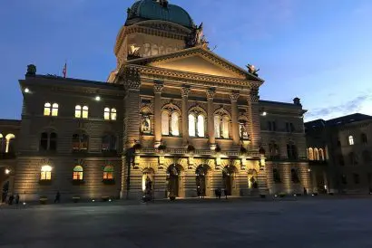 The ornate Swiss parliament building, illuminated at dusk