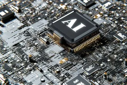 A computer circuit board containing a large chip with the letters 'AI' printed on it.